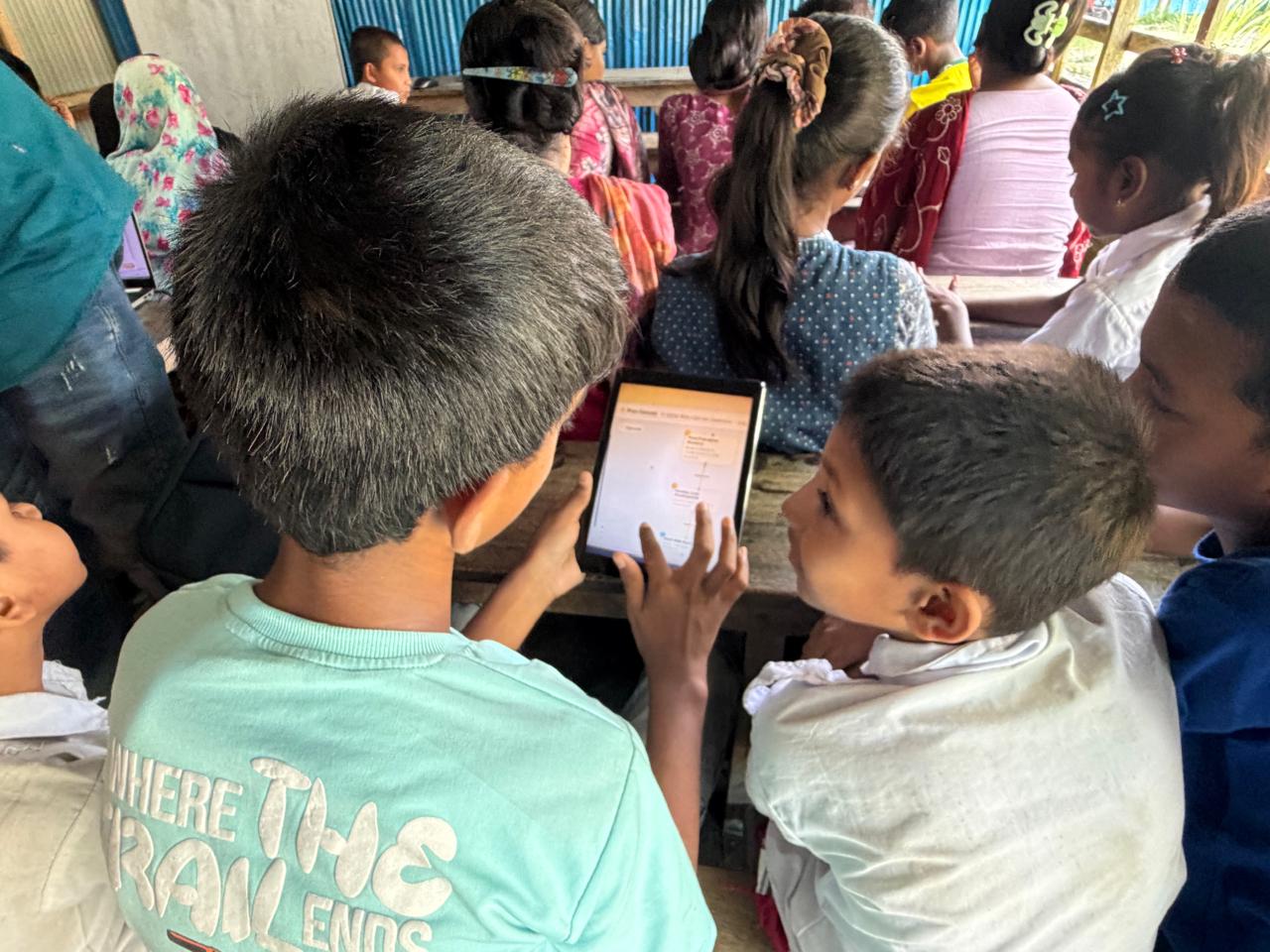 Two students reading a plan canvas together on a tablet